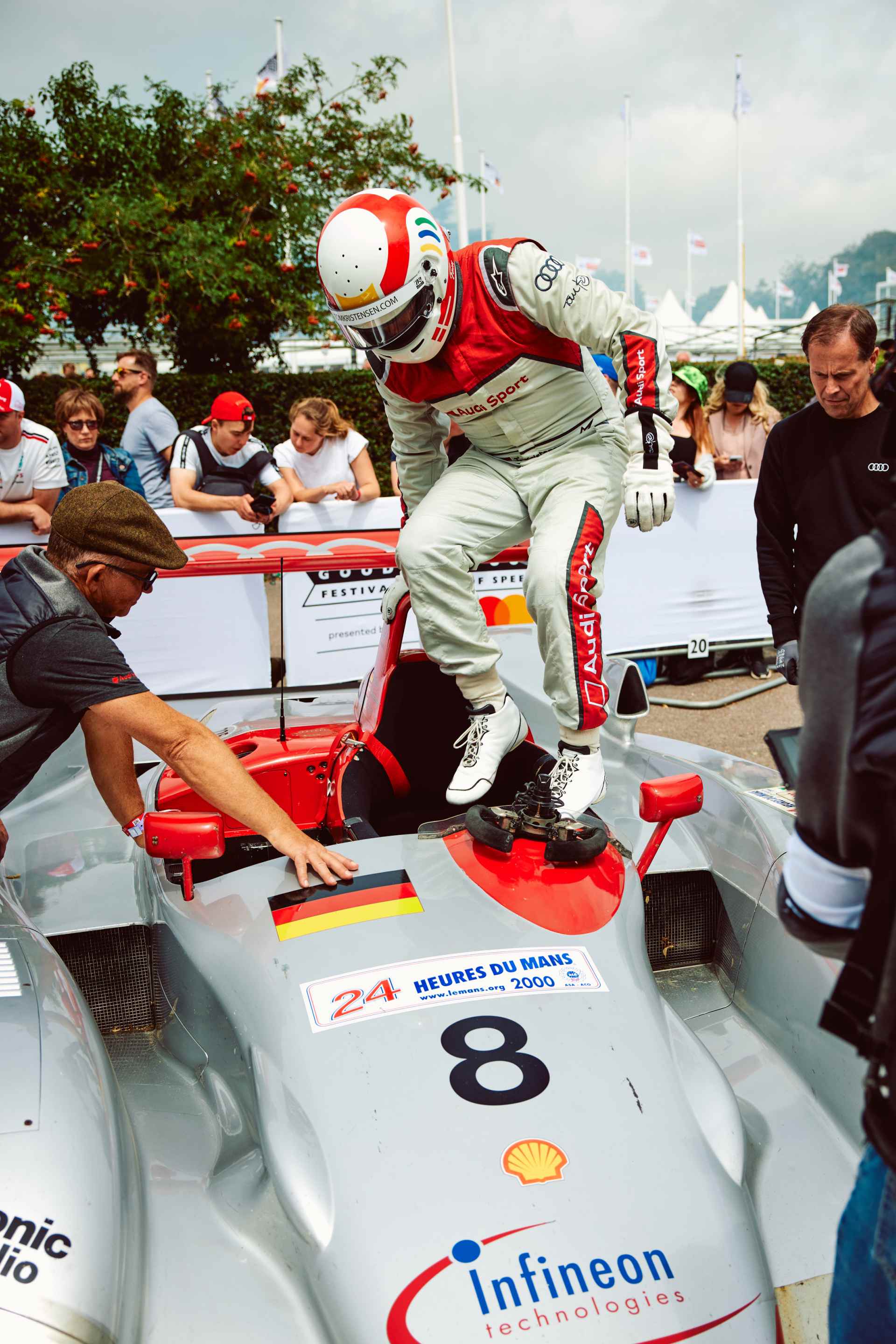 Tom Kristensen jumps into the cockpit of an Audi R8 LMP1.