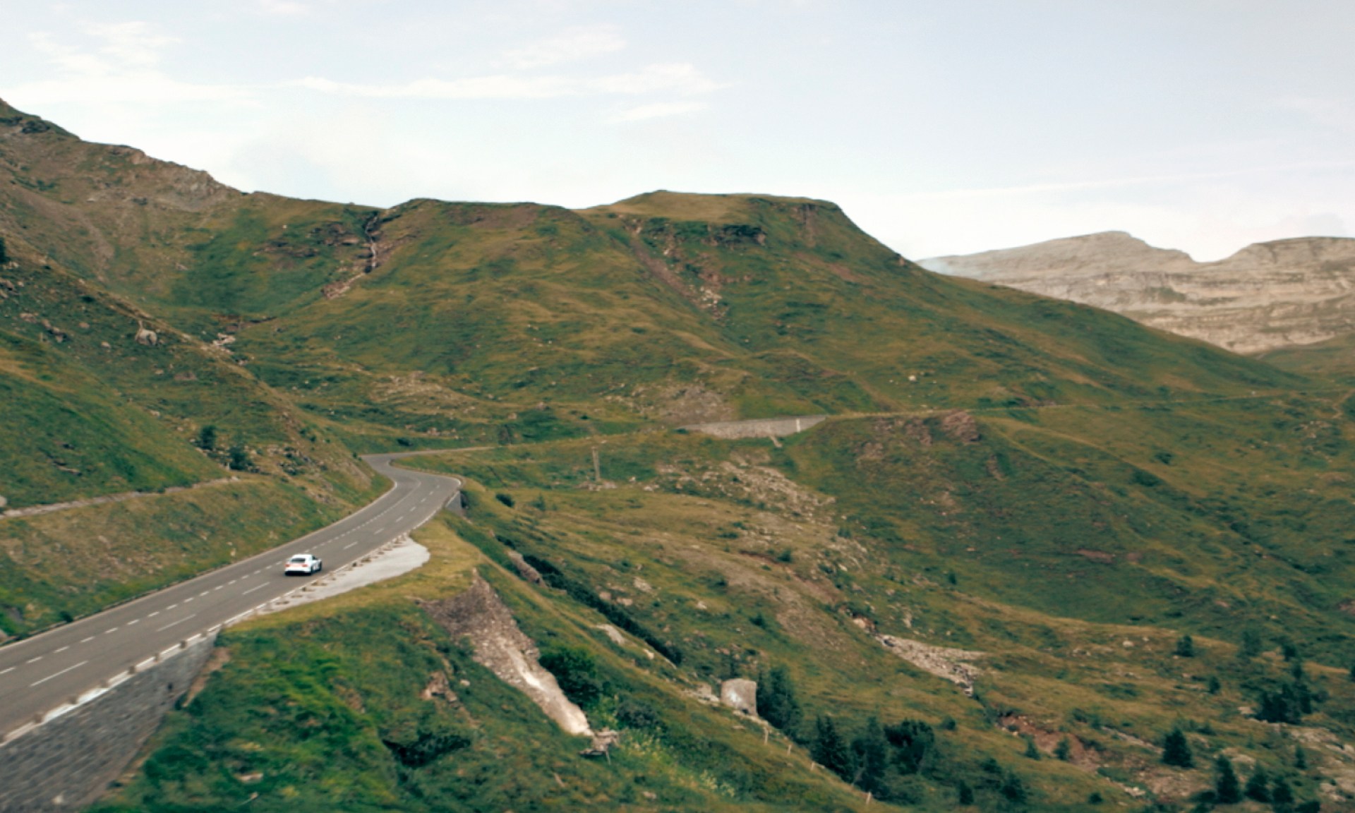 The Audi RS e-tron GT ice race edition driving through a mountain landscape.