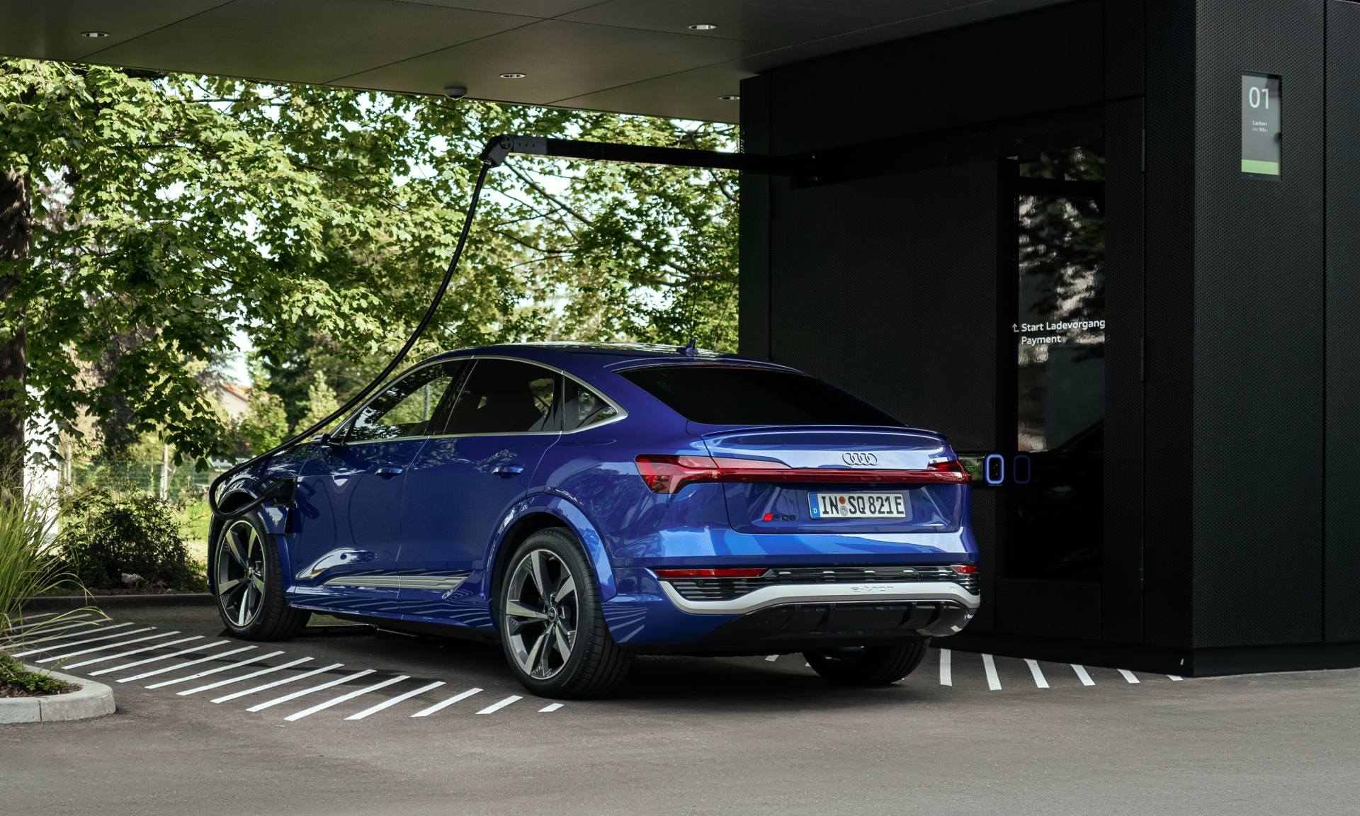 The Audi SQ8 Sportback e-tron at a charging point.