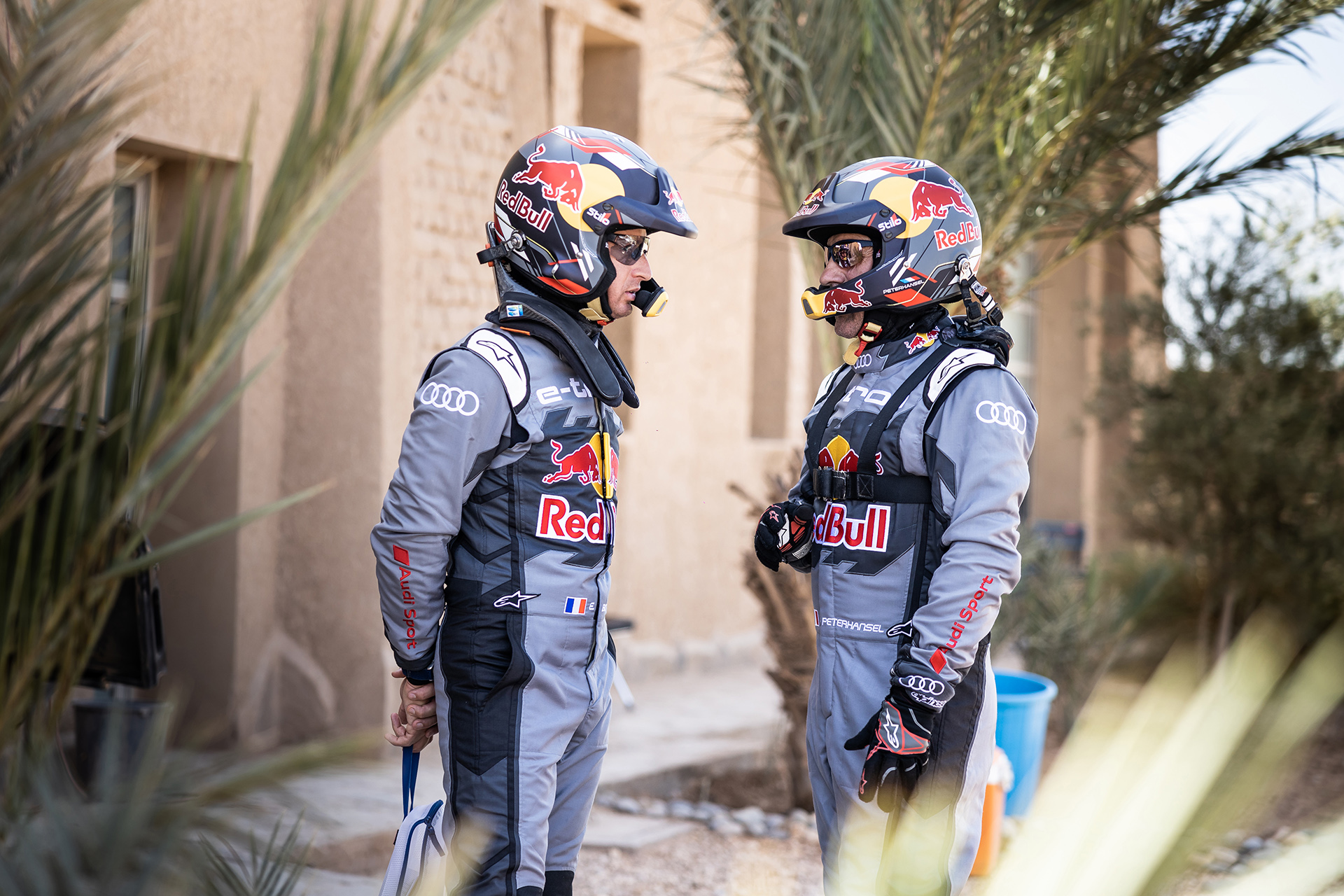 Peterhansel and Boulanger talking outside the vehicle.