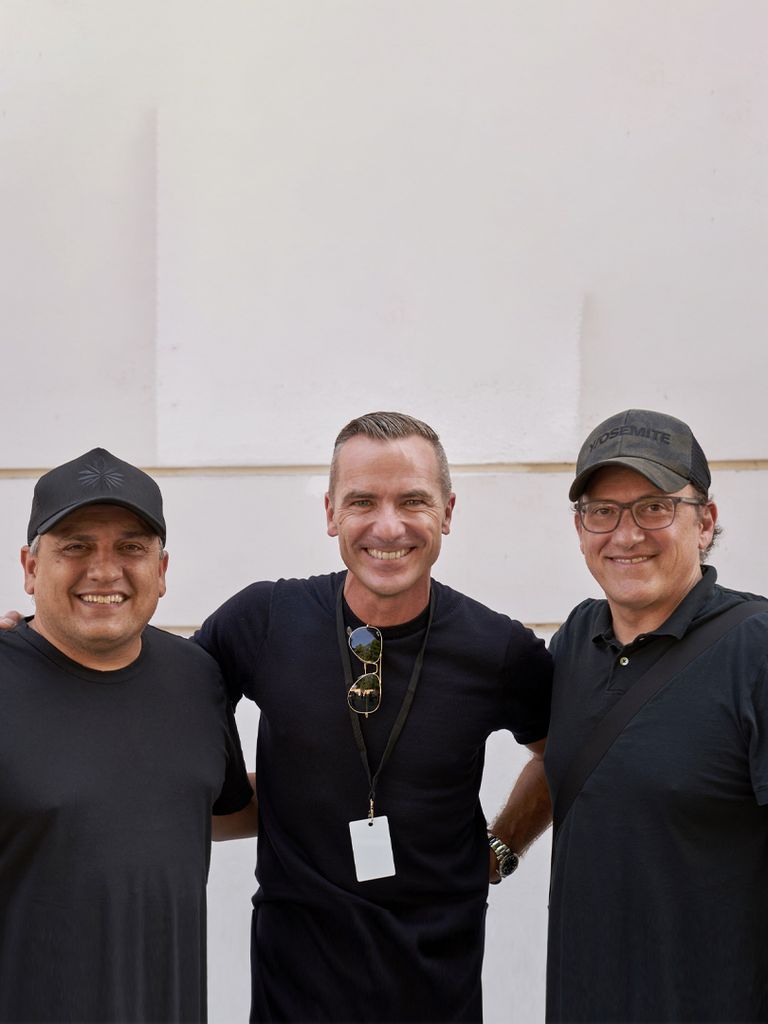 Joe and Anthony Russo and Henrik Wenders smile at the camera.