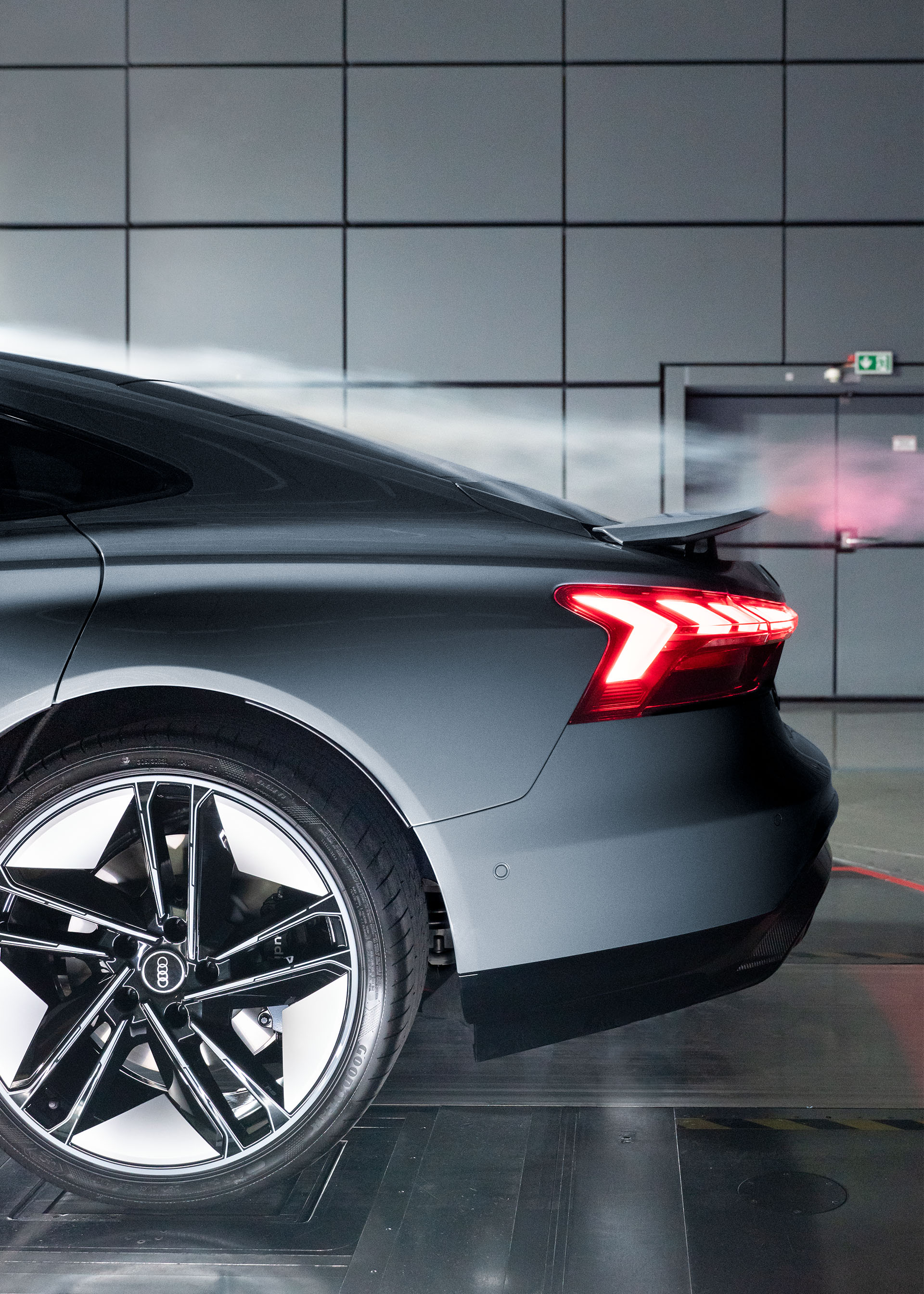 Smoke flows over the rear spoiler of the Audi RS e-tron GT.