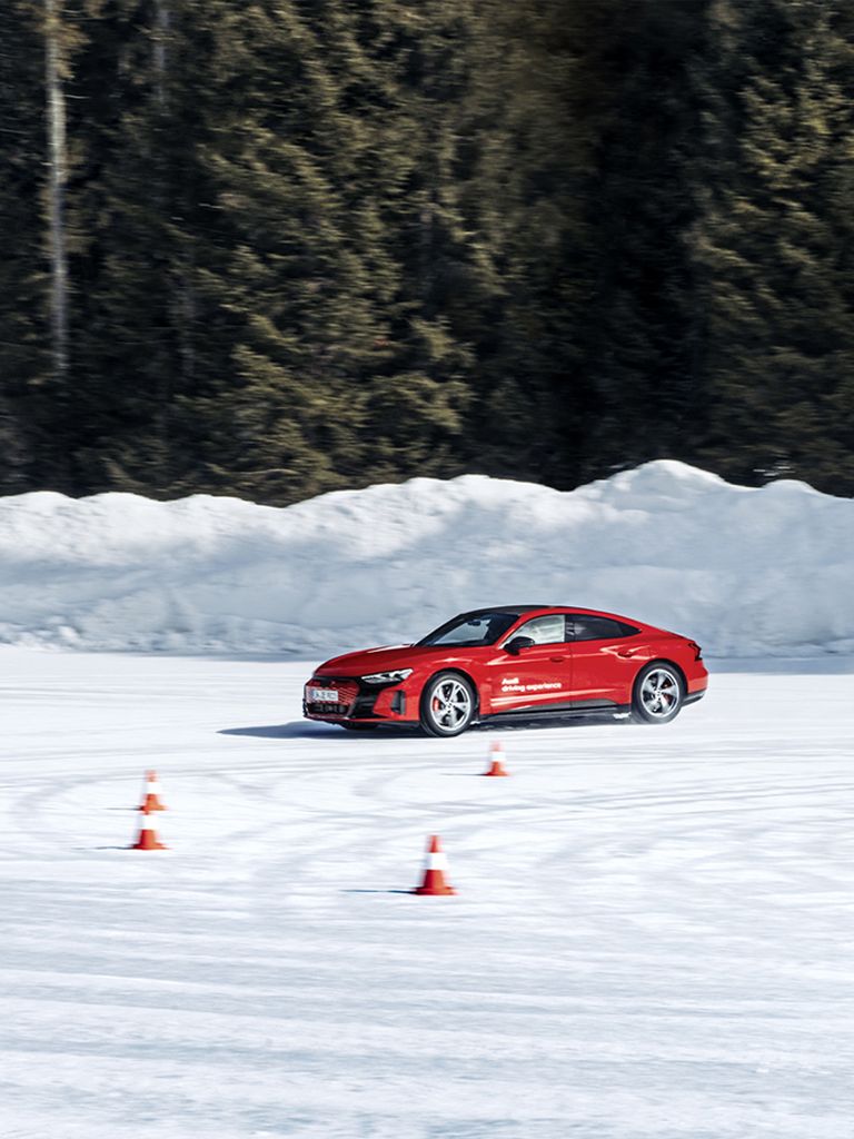 The Audi RS e-tron GT drifts in a circle around the Audi Q4 e-tron.