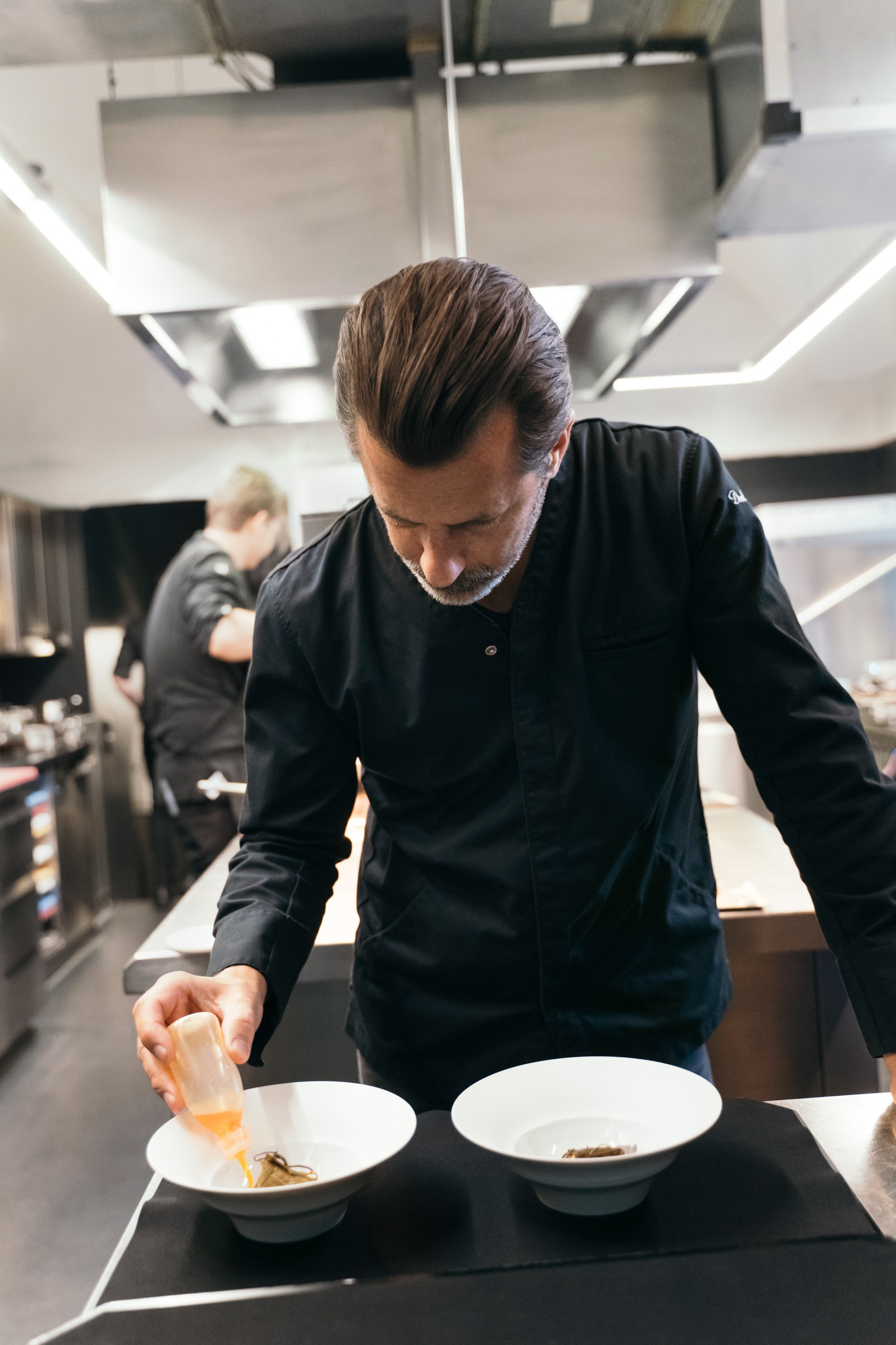 Andreas Caminada arranging his plates.