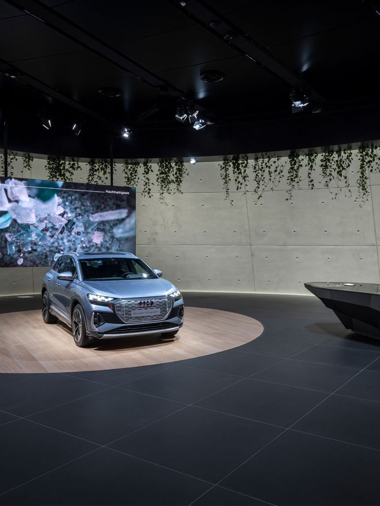 The Audi Q4 e-tron and a projection on sustainability. Next to them the information desk.