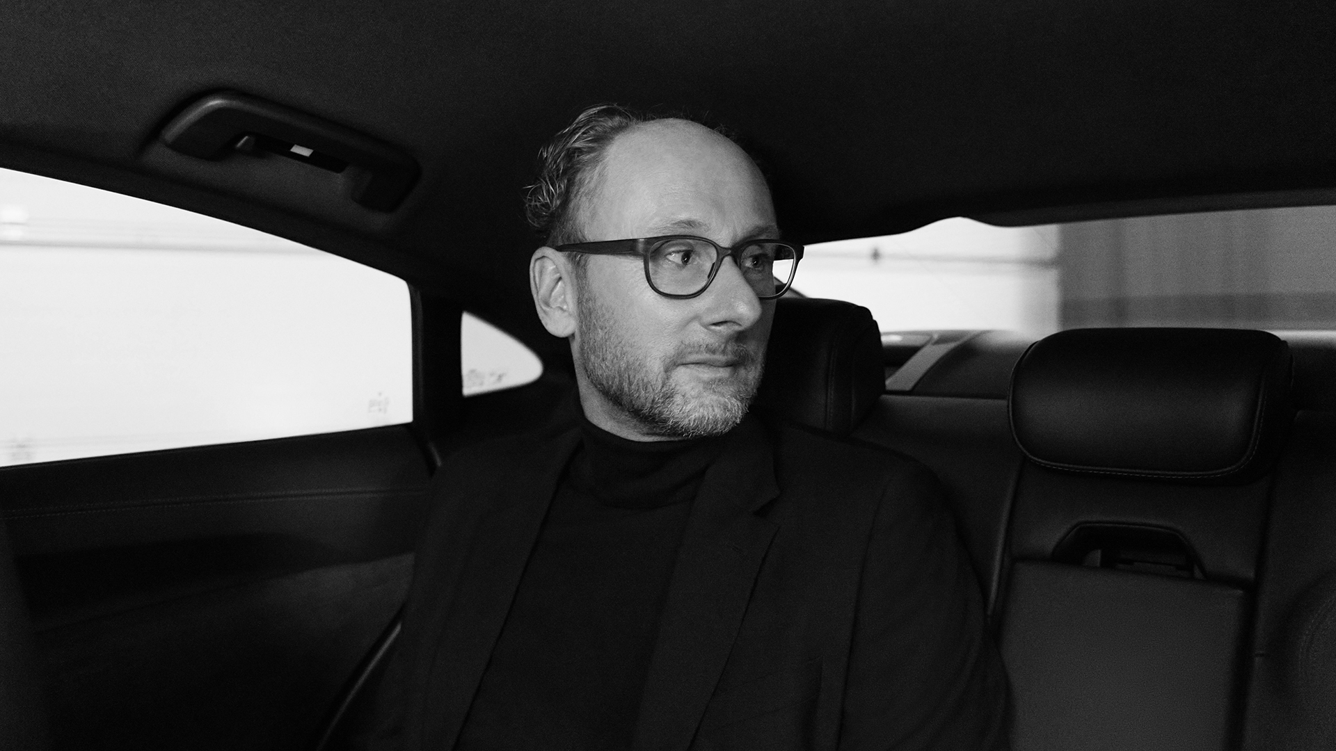 Portrait of Marc Lichte in the back of the Audi RS e-tron GT.