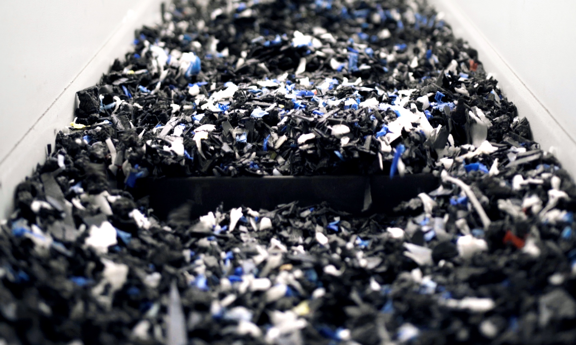 Plastic granules on a conveyor belt. 