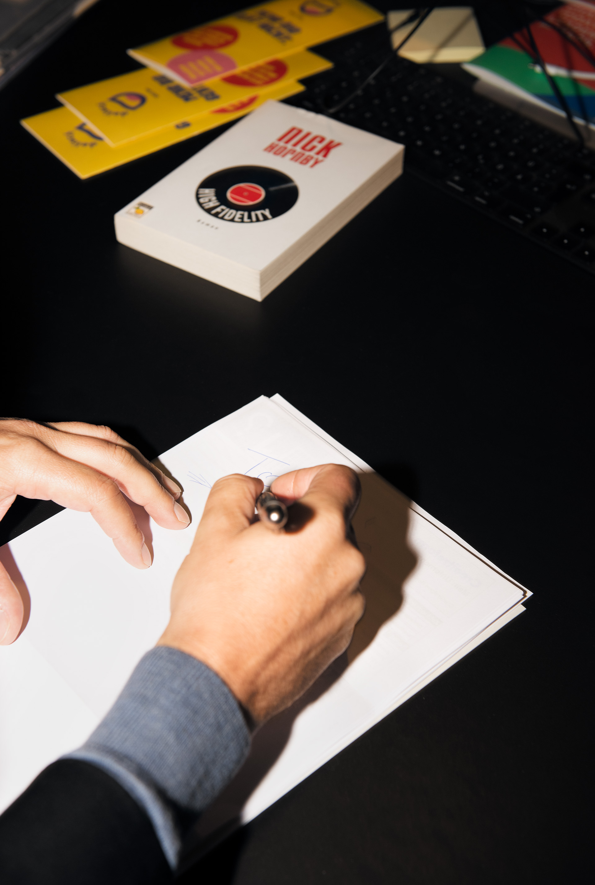 Marco Voigt writing on a blank sheet of paper.